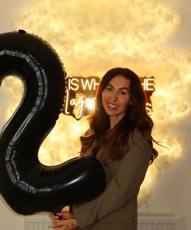 Glowing neon cloud reading 'this is where the magic happens' inside By Bex & Co